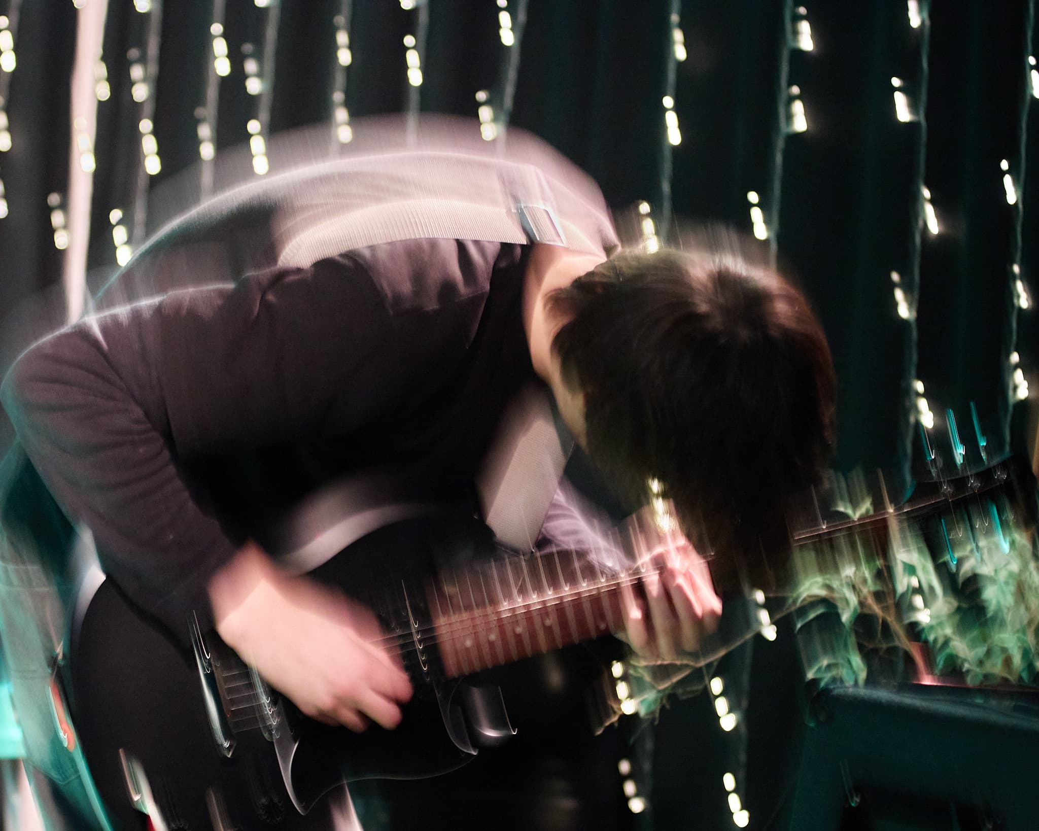 Koncerto energija su judesio efektu Gitaristas scenoje nufotografuotas su ilgesniu išlaikymu ir judesio efektu
